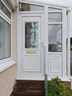 a white door with a floral design on it at Studio Twenty One in Whitburn