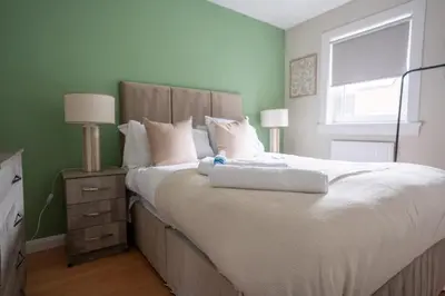 a bedroom with a large bed and a window at Graham House in Livingston