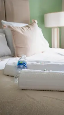 a bottle of water sitting on top of a bed at Graham House in Livingston