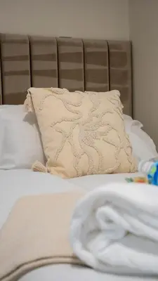 a white bed with a pillow and a blanket at Graham House in Livingston
