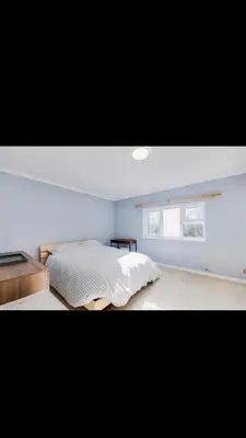 a bedroom with a bed and a window at Modern home Close to all Cardiff venues in Moffat