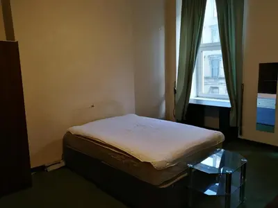 a small bed in a room with a window at Glasgow Entire Property in Glasgow
