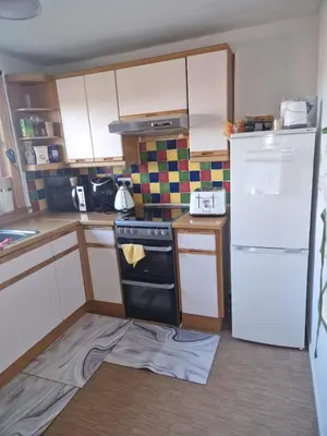 a kitchen with a stove and a refrigerator at Vibrant Room in Centeral Ayr in Ayr