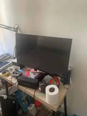 a computer monitor sitting on top of a desk at Gravesend one room apartment in Moffat