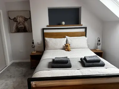 a bedroom with a bed with a stuffed animal on it at No4 Invereoch in Arrochar