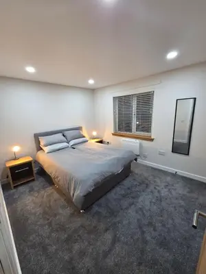 a bedroom with a large bed and a window at 25 Colliers Road,Stirling