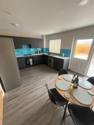 a room with a table and chairs and a kitchen at 25 Colliers Road,Stirling