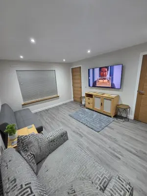 a living room with a couch and a flat screen tv at 25 Colliers Road,Stirling