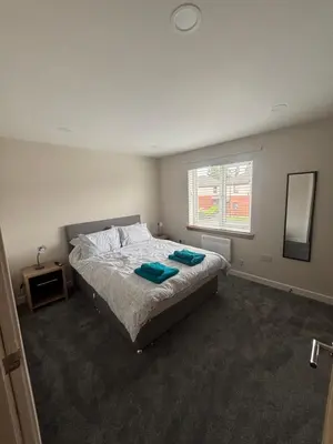 a bedroom with a bed with two towels on it at 25 Colliers Road,Stirling