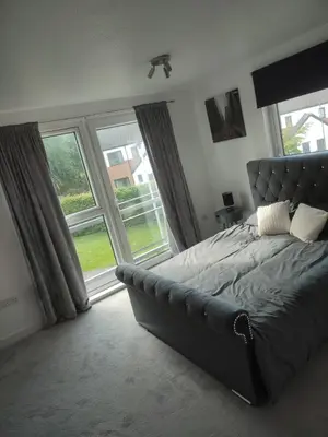 a bedroom with a bed and a large window at Rosebank Apartment Edinburgh City in Edinburgh