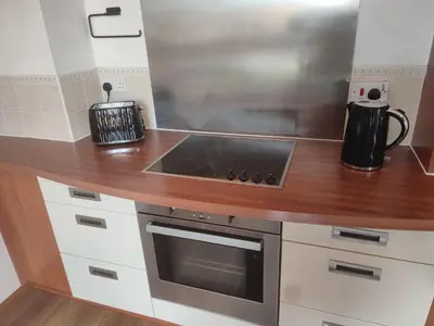 a kitchen with a stove and a counter top at Rosebank Apartment Edinburgh City in Edinburgh