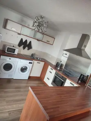 a kitchen with white appliances and a stove top oven at Rosebank Apartment Edinburgh City in Edinburgh