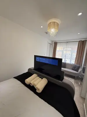 a bedroom with a bed and a flat screen tv at Edinburgh city break room in Edinburgh