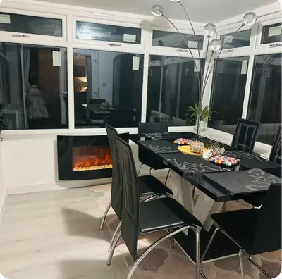 a dining room with a table and a fireplace at Edinburgh city break room in Edinburgh