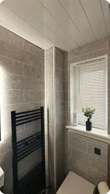 a bathroom with a toilet and a window at Edinburgh city break room in Edinburgh