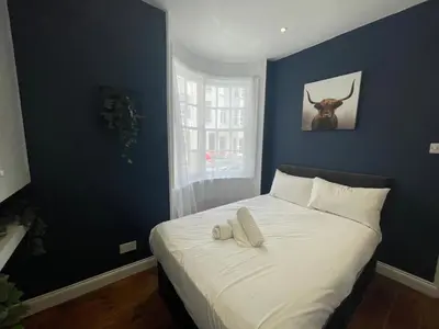 a bedroom with a bed with a bull skull on the wall at First Avenue Apartments in Moffat