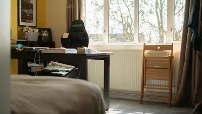 a bedroom with a desk and a window at 3 bedroom cosy apartment 20 mins to Centre in Moffat