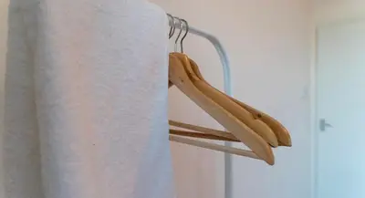 a pair of wooden shoes hanging on a towel rack at 3 bedroom cosy apartment 20 mins to Centre in Moffat