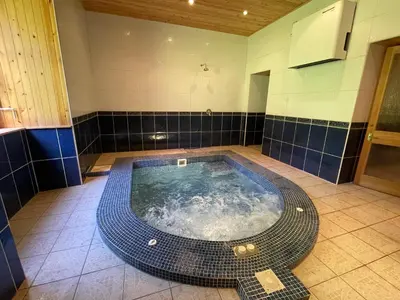 a jacuzzi tub in the middle of a bathroom at Craigielands House in Beattock