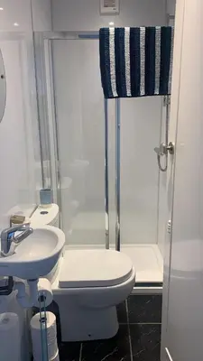 a bathroom with a toilet and a sink and a shower at The Port in Port Bannatyne