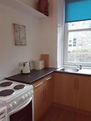 a kitchen with a stove and a sink at The Port in Port Bannatyne