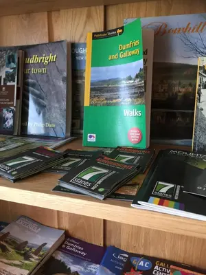 a display of books on a shelf at Stables Guest House in Newton Stewart