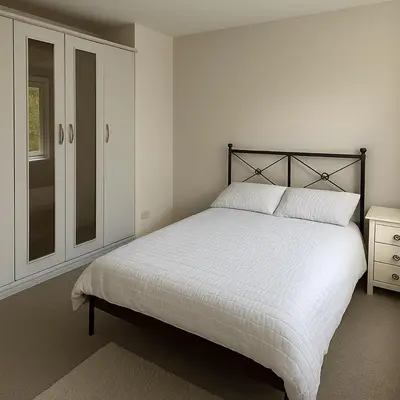 a white bedroom with a bed and a window at Cozy 2BR Flat Near City Centre Free Parking Fast Wifi in Edinburgh