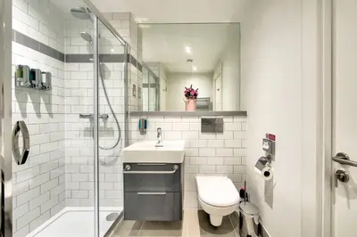 a bathroom with a toilet and a sink and a shower at Lovely 1-Bedroom Unit Near Edinburgh Castle in Edinburgh