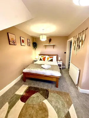 a bedroom with a bed and a rug at Duplex - City Centre 4-Bed Retreat in Edinburgh