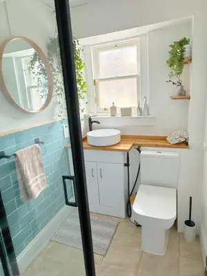 a bathroom with a toilet and a sink and a mirror at Duplex - City Centre 4-Bed Retreat in Edinburgh