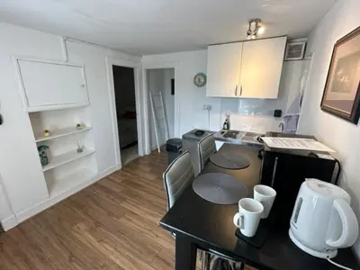 a kitchen with a table and a counter top at Castle Walk Apartment in Stirling