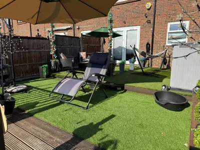 a yard with a chair and an umbrella at Traveler Nest in Moffat