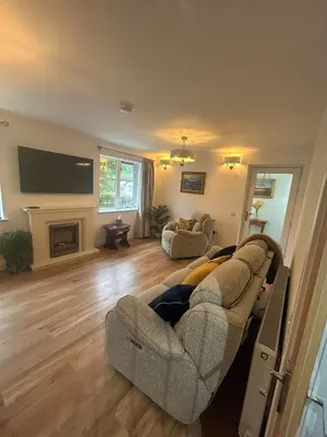 a living room with a couch and a fireplace at The West Wing - 1Bedroom Annexe with parking in Oban