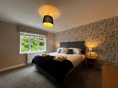 a bedroom with a large bed and a window at The West Wing - 1Bedroom Annexe with parking in Oban