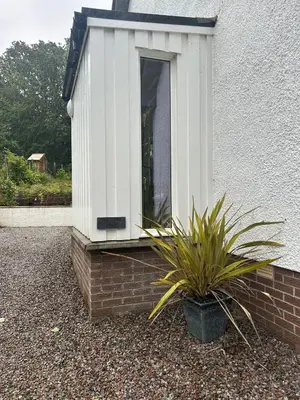 a window on the side of a house with a plant at The West Wing - 1Bedroom Annexe with parking in Oban