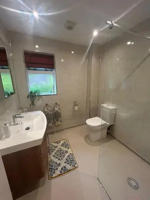 a bathroom with a sink and a toilet and a shower at The West Wing - 1Bedroom Annexe with parking in Oban