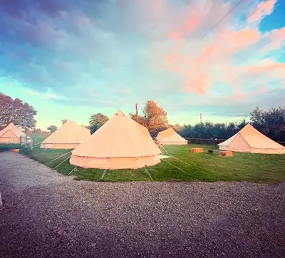 a group of tents sitting on the grass at Infinite Sky camping in Moffat