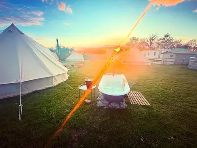 a tent and a toilet sitting in a field at Infinite Sky camping in Moffat