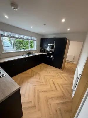 a large kitchen with a wooden floor and appliances at Best stay in the bay in Saint Davids