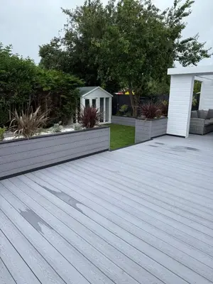 a wooden deck in a yard with a garden at Best stay in the bay in Saint Davids