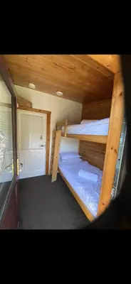 two bunk beds in a room with wooden ceilings at Rowardennan Rooms in the lodge Lodge no 2 in Rowardennan
