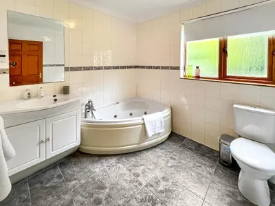 a bathroom with a tub and a sink and a toilet at Foxglove Cottage 2 - Uk50020 in Drymen