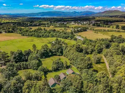 an aerial view of a field with trees and houses at Foxglove Cottage 2 - Uk50020 in Drymen