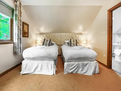 a bedroom with two beds with white sheets at Foxglove Cottage 2 - Uk50020 in Drymen