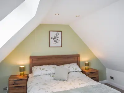 a bedroom with a bed and two night stands at High Wardneuk - Uk47041 in Symington