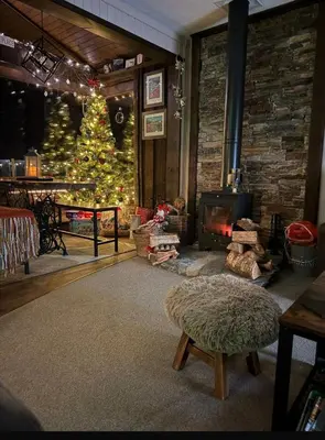 a living room with a christmas tree and a fireplace at Breacan Lodge in Hunters Quay