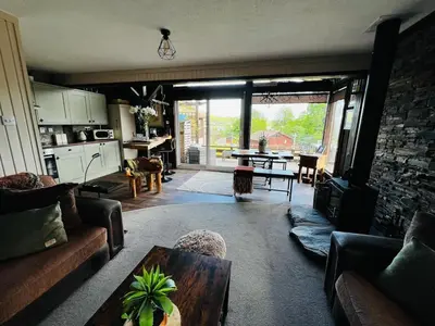 a living room with a couch and a table at Breacan Lodge in Hunters Quay