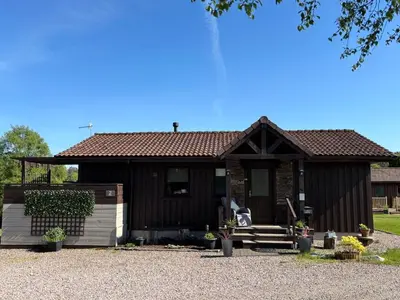 a small house with a brown roof at Breacan Lodge in Hunters Quay