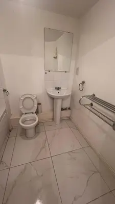 a bathroom with a toilet and a sink at comfy residence in Moffat