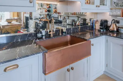 a kitchen with a sink and a counter top at Luxury West End flat with stunning bay window views in Edinburgh